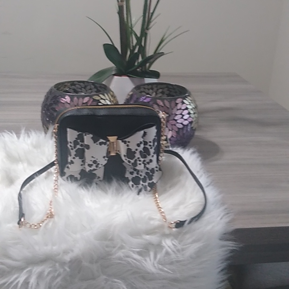 Small black pocketbook with black and white bow